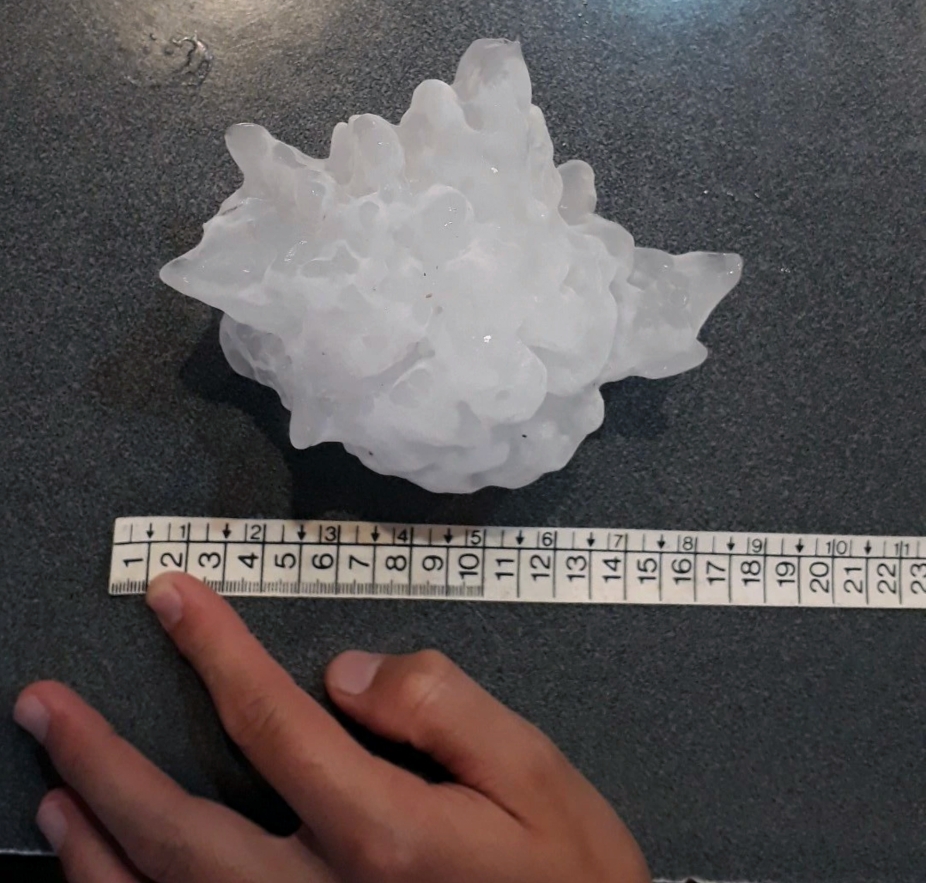 Measuring a gargantuan hailstone.