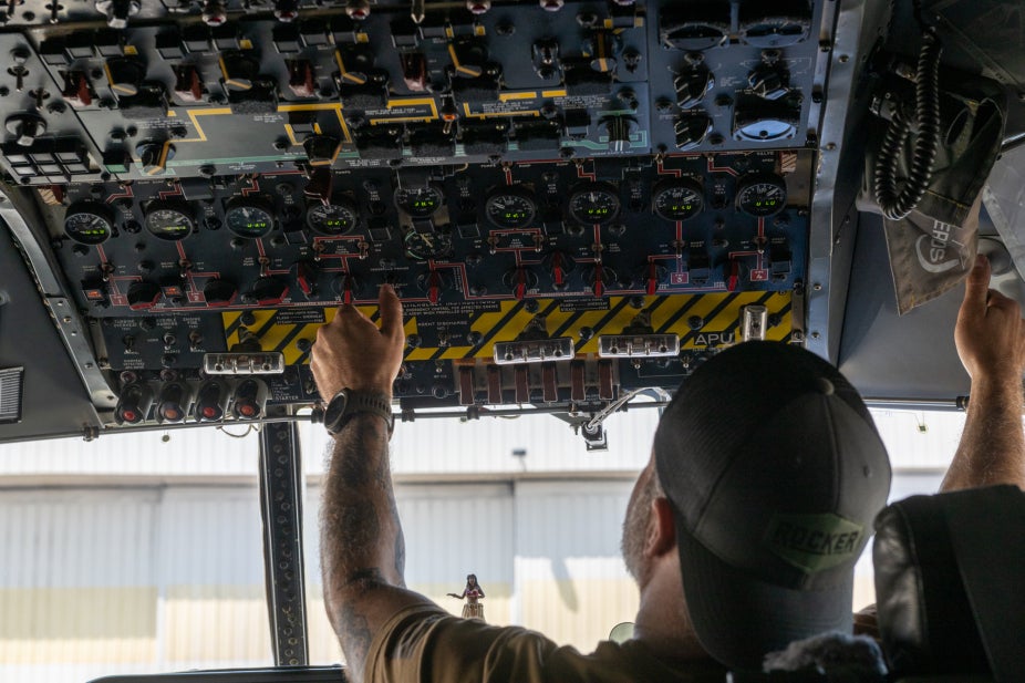 Flight engineer for the NSF NCAR C-130 preps controls before takeoff.