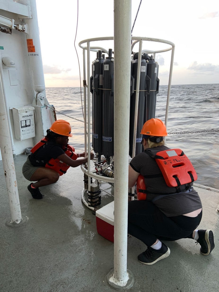 REU students work on a ship