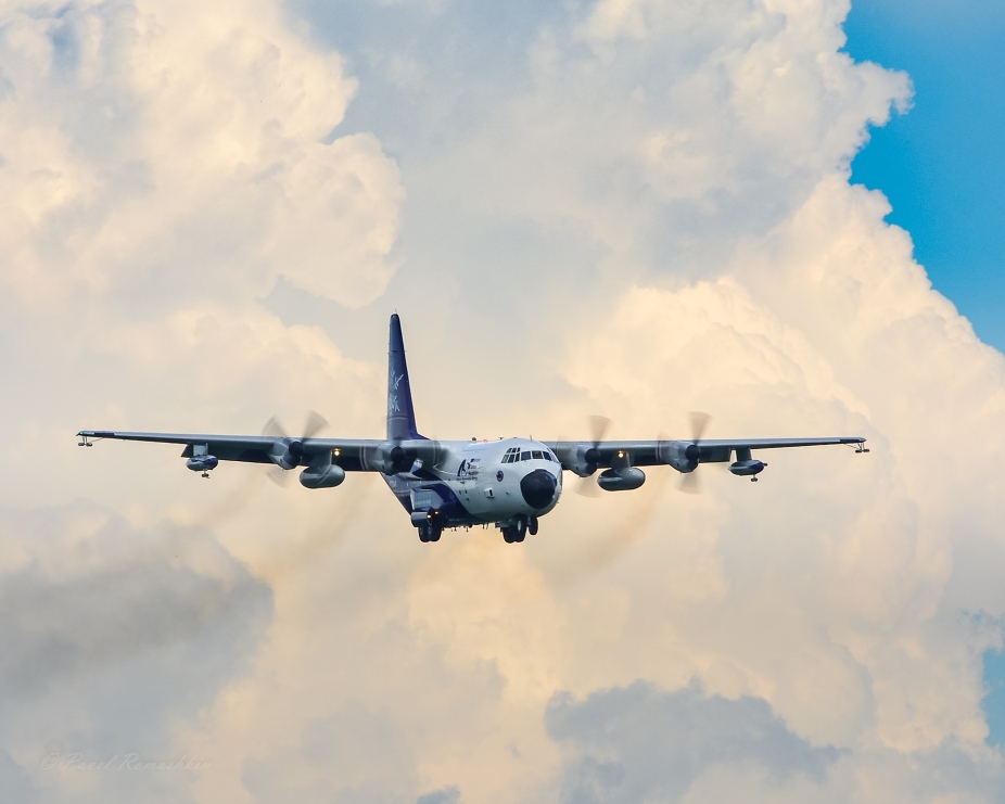 The NCAR C-130 research aircraft flying with clouds in the background