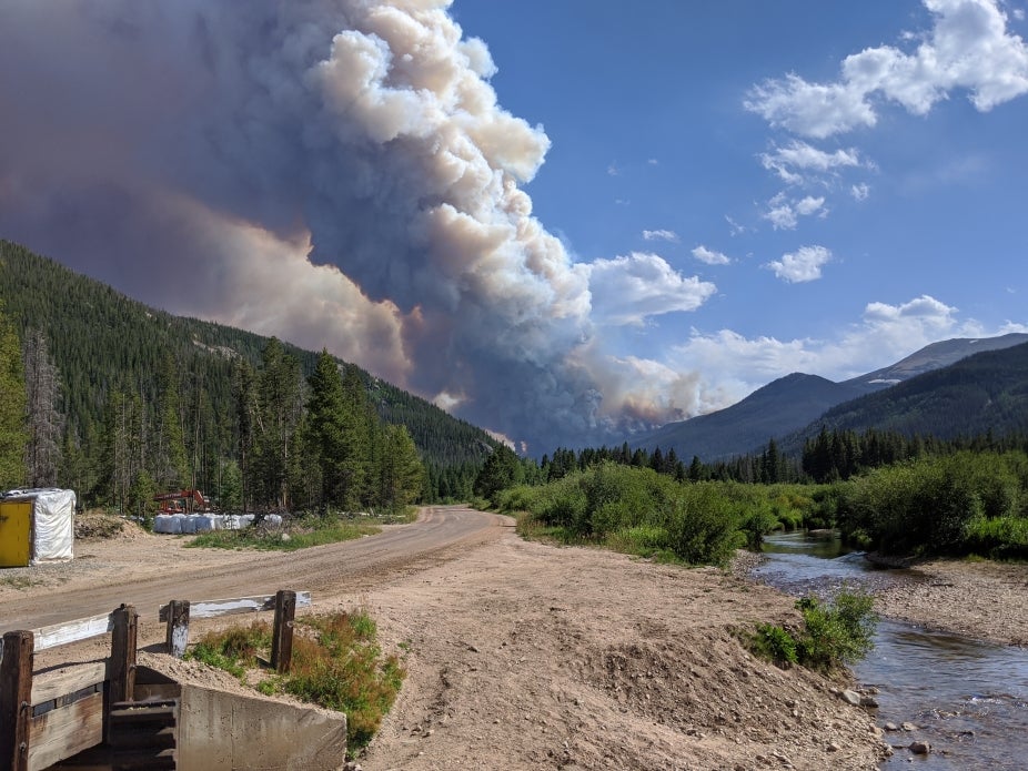 The Cameron Peak wildfire rages on a distant peak.