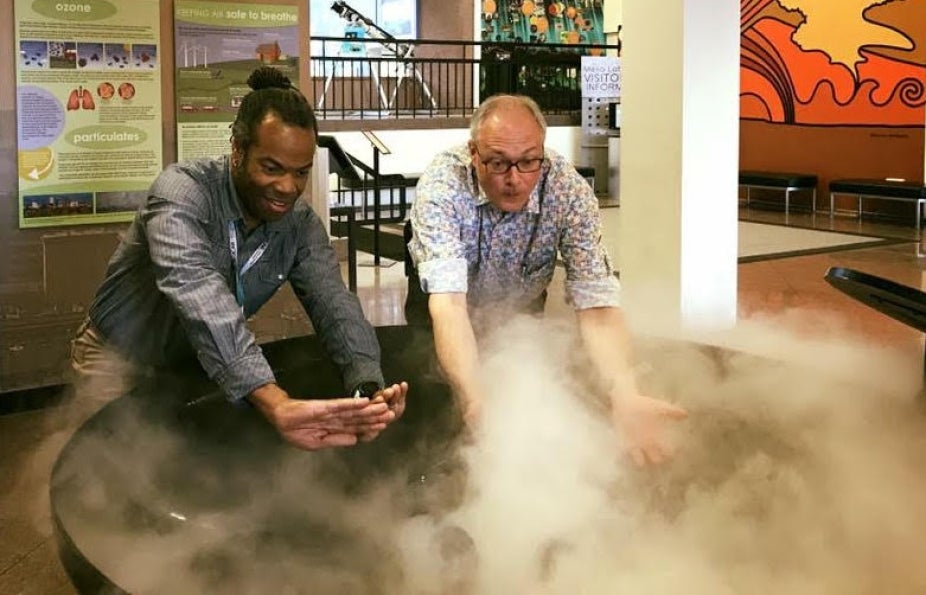 Jo Hecker interacts with Tim of NCAR to explore clouds at NCAR's Mesa Lab weather exhibit