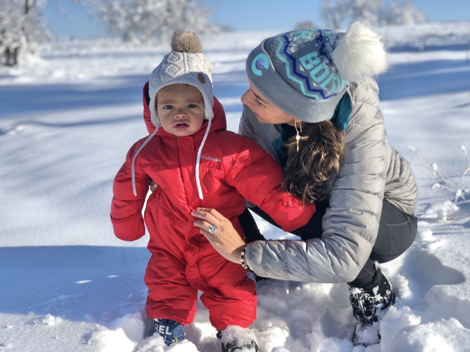 Rosimar Rios-Berrios with her child in the snow, bundled in winder clothes.