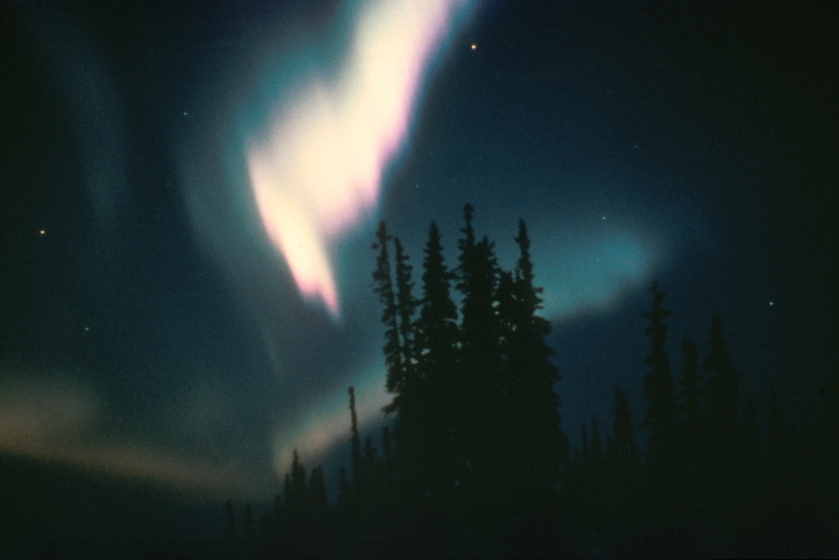 Solar winds and other forms of solar activity are responsible for luminous streams of light known as the aurora, which appear in the sky mostly over polar latitudes. Solar storms emit streams of electrically charged particles that bombard the ionized, highly rarefied gases in the upper air. These gases, mostly oxygen and nitrogen, are excited by the particles and, as a result, glow like a neon light.