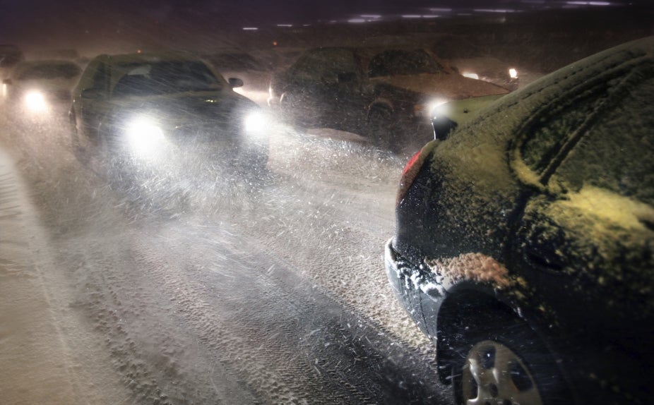 Cars driving in traffic on a snowy road