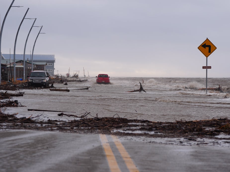 A coastal road floods from high seas