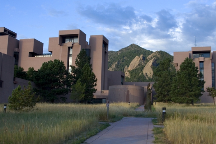 NCAR building taken from sidewalk with Boulder Flatirons in the background