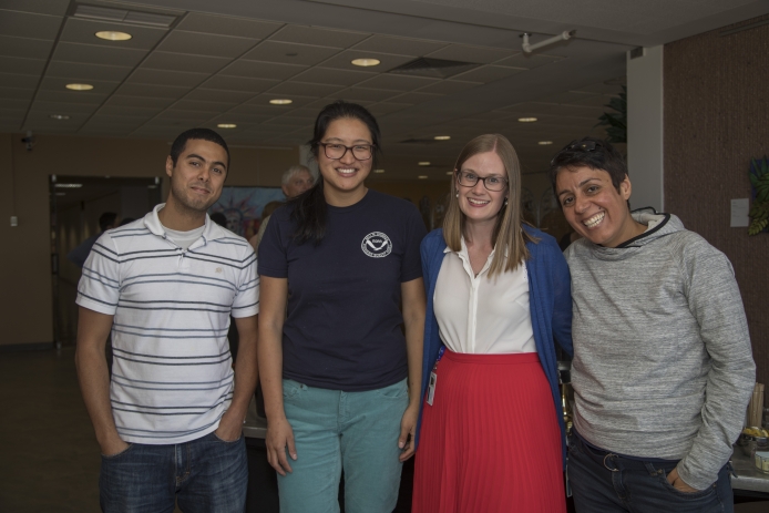Four postdocs pose together at a function