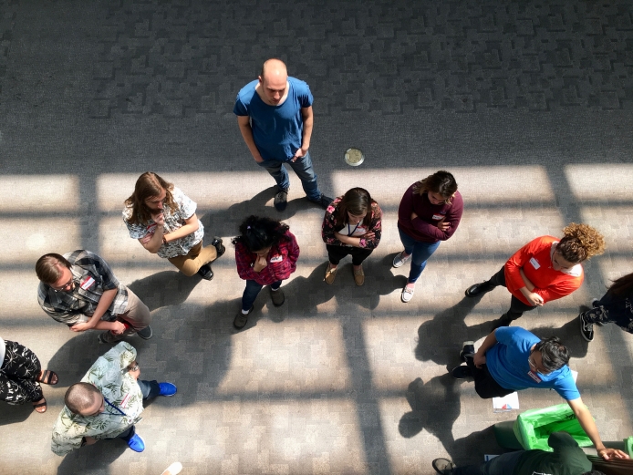 Aerial view of people standing in a semi-circle during professional development training