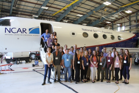 Group of undergraduates pose in front of a research aircraft