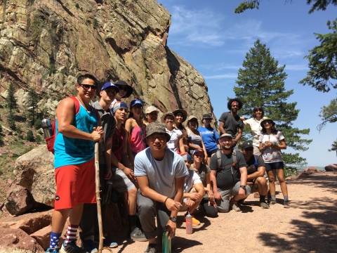 A group of students pose together during a hike
