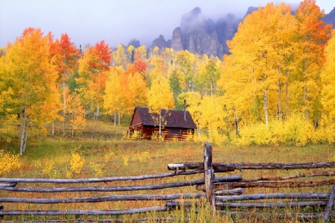 Uncompahgre area barn and fence with aspens and fog photographed in Fall near Ridgway, Colorado