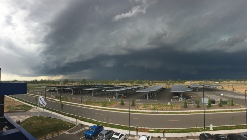 A large storm approaches a solar carport facility