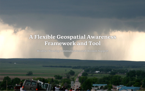 Onlookers view a tornado about to touch ground in the distance