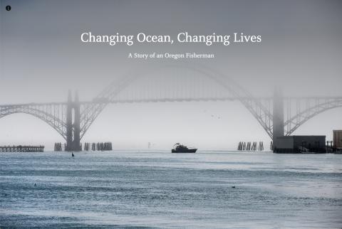 A fishing boat passes underneath a foggy bridge