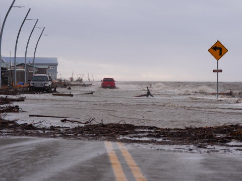 A coastal road floods from high seas