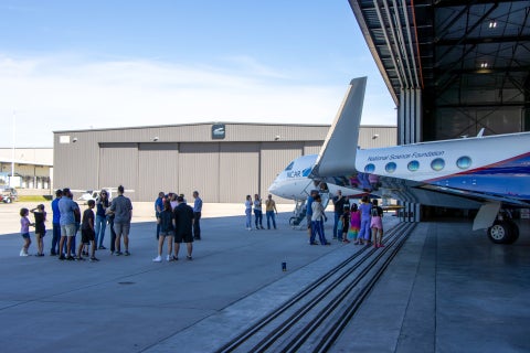 Community members speak with NSF NCAR staff while they explore the NSF NCAR Gulfstream-V research aircraft.