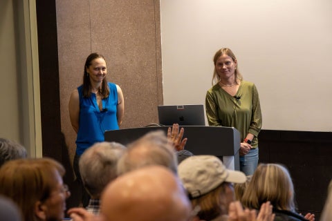 NSF NCAR scientists present their research to a large crowd